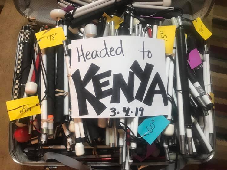 A bundle of canes with names attached to them with a sign that reads, "Headed to Kenya!'