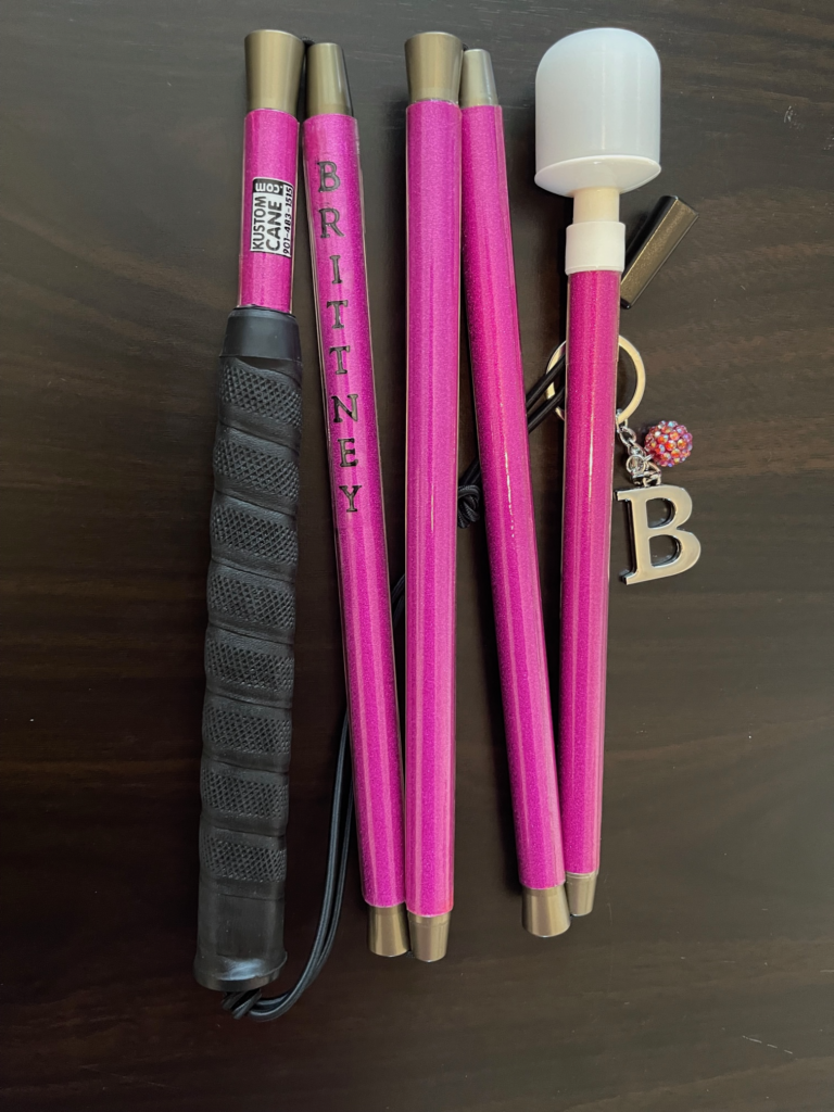 Image of our 5-section aluminum folding cane depicting one of our over 250 colors! This cane is a hot pink cane that is accented with the name "Britney."