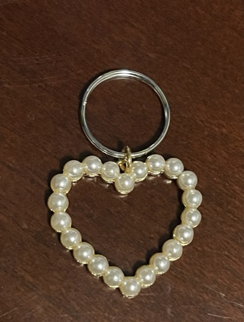 White Heart outline charm with pearl detailing. The heart is hanging from a silver ring.