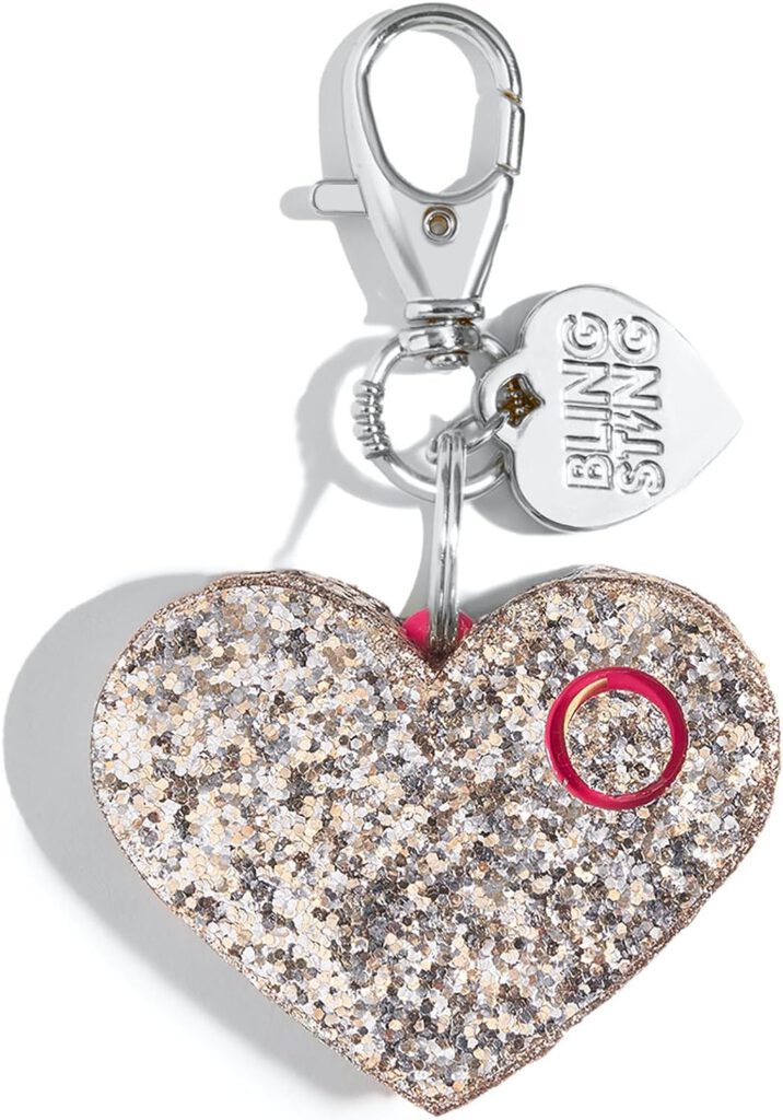 Champagne-colored, glittery, Heart-shaped alarm charm hangs from a silver chain with clip-on chain