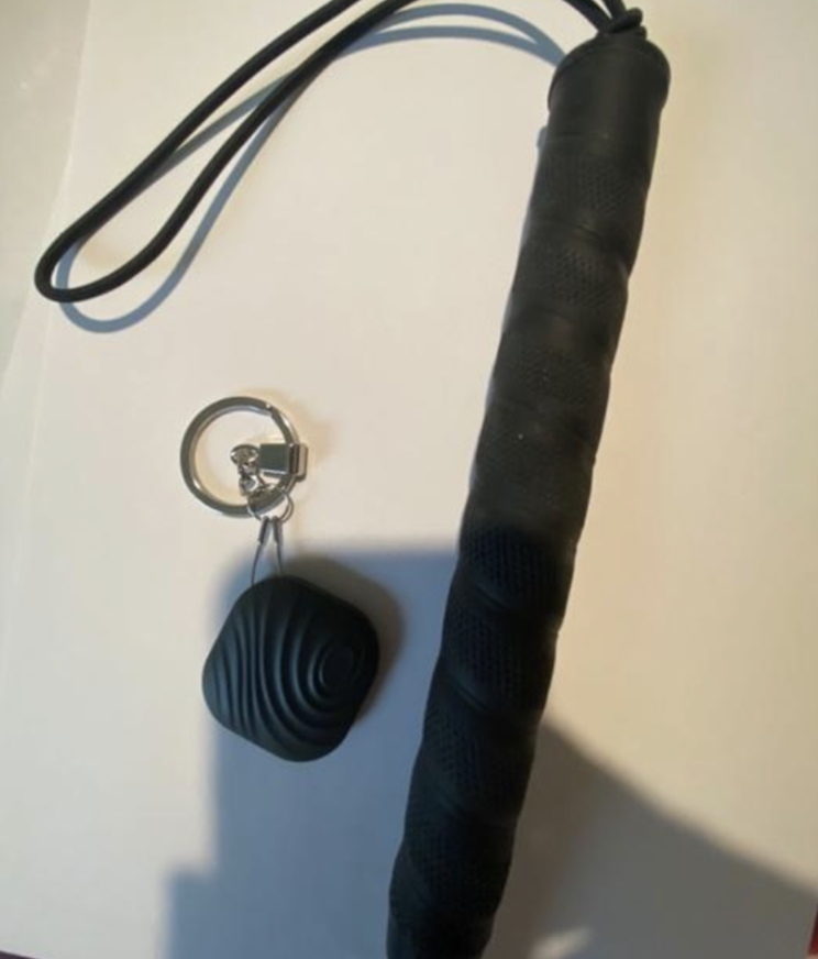 black, square-shaped, bluetooth, cane finder charm, hanging from a cane wrist strap