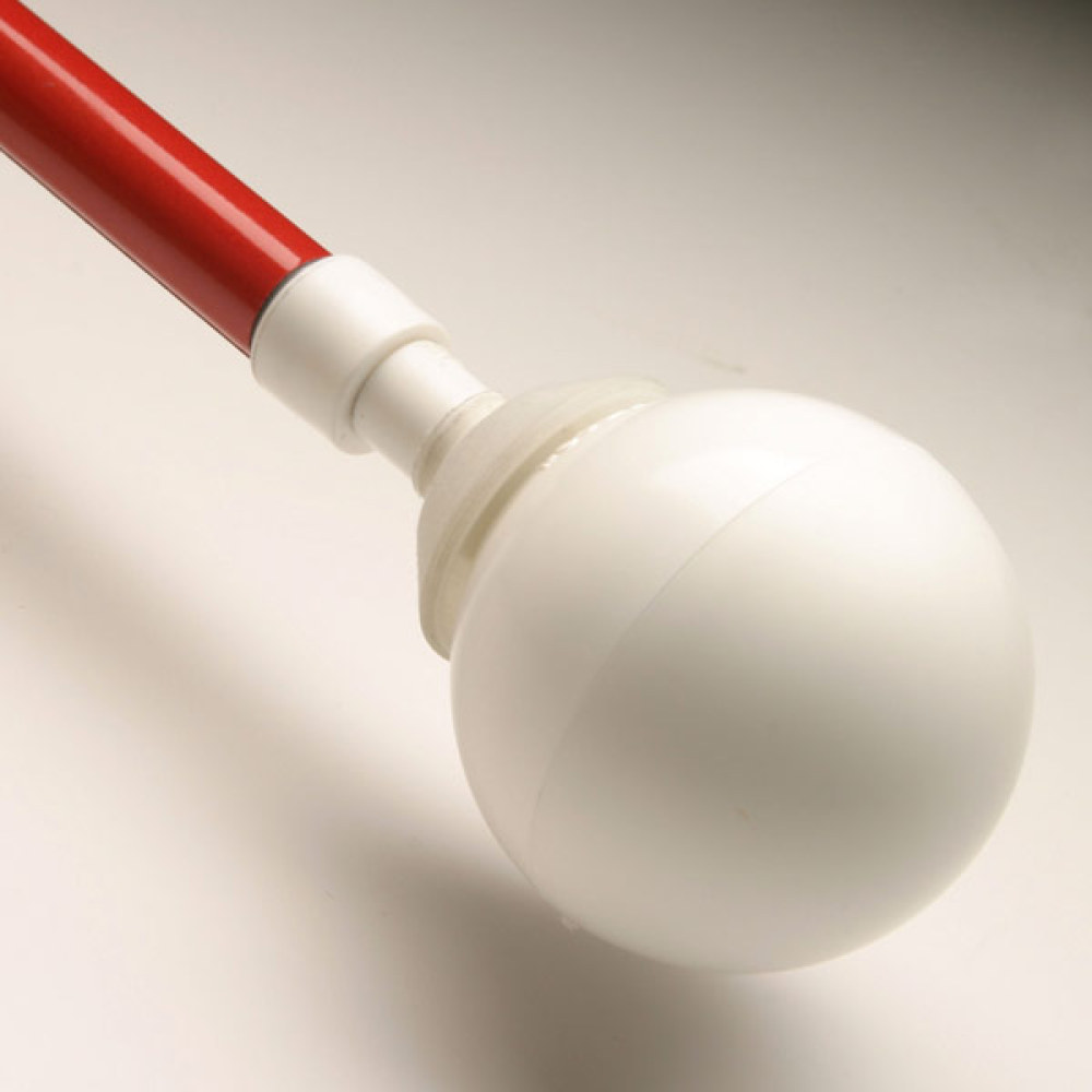 White Rolling Ball Cane Tip attached to the end of a red cane against a tan background.