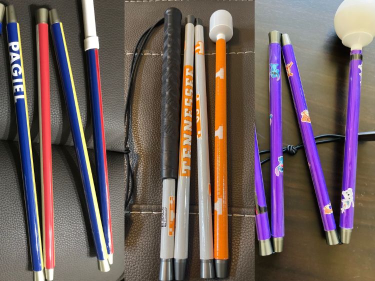 Three side by side images of customized canes. The first cane is a Blue, Yellow and Red striped Romania-Themed Folding Cane. The second cane is a white and orange University of Tennessee Volunteers themed folding cane. The third cane is a purple folding cane with disney character graphics.