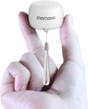 two fingers holding the white tiny bluetooth speaker