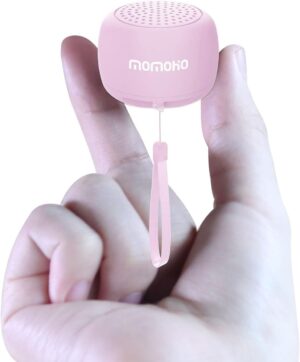 two fingers holding the pink tiny bluetooth speaker