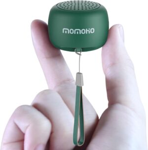 two fingers holding the green tiny bluetooth speaker