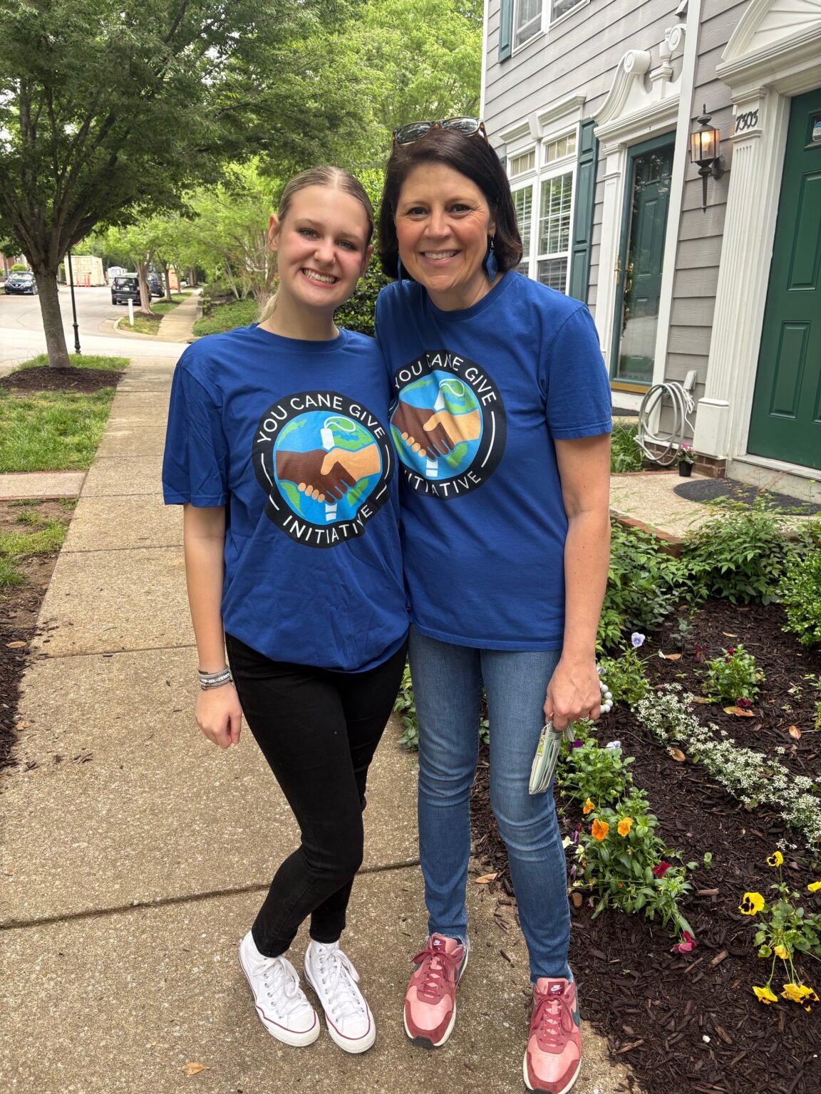 Wendy standing and smiling with a volunteer in a hallway